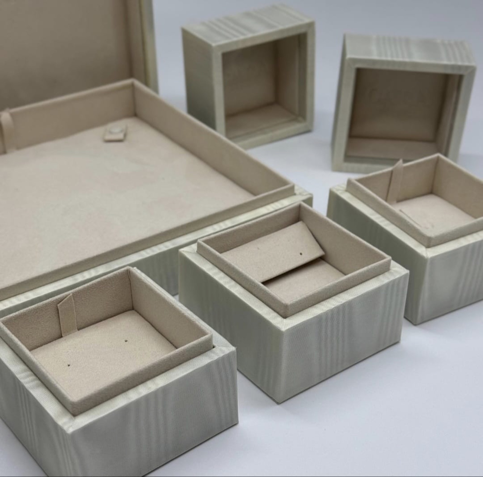 Ivory moiré jewellery boxes with suede inserts